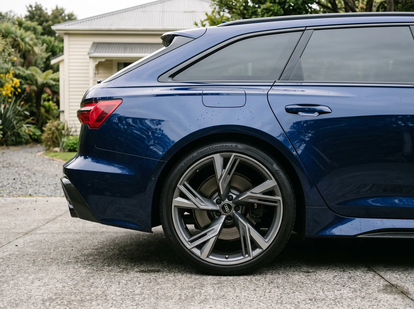 Illustrative close-up of a clean blue Audi wheel and paintwork